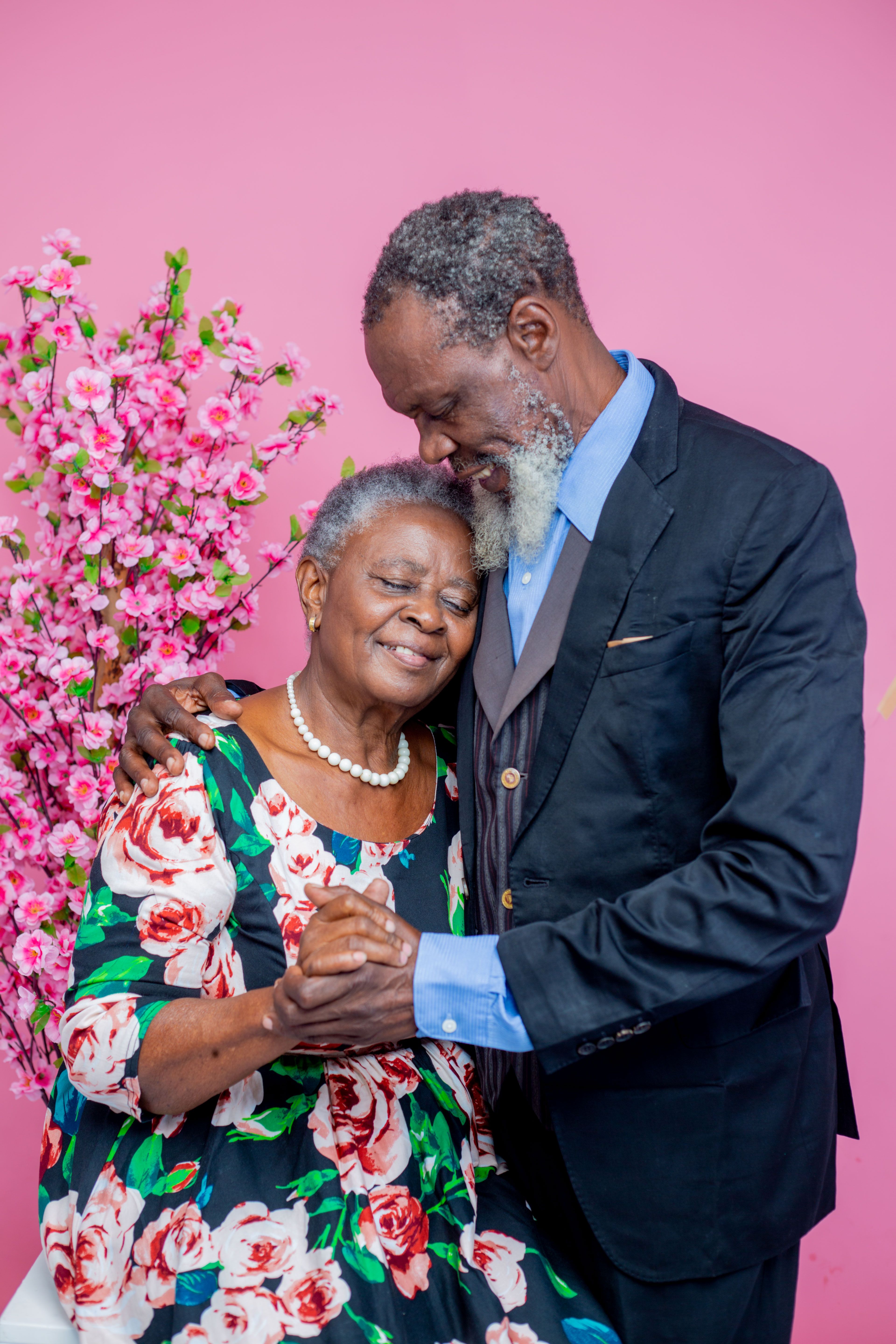 An elderly couple embracing warmly, dressed smartly — Eagle Finance welcomes pensioners and grant recipients